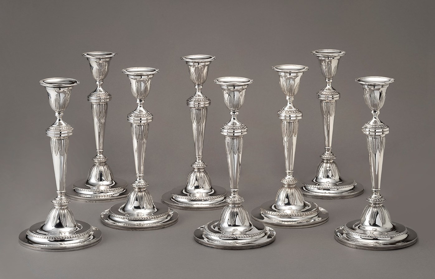 A rare set of eight silver candlesticks by François Marcus Simons